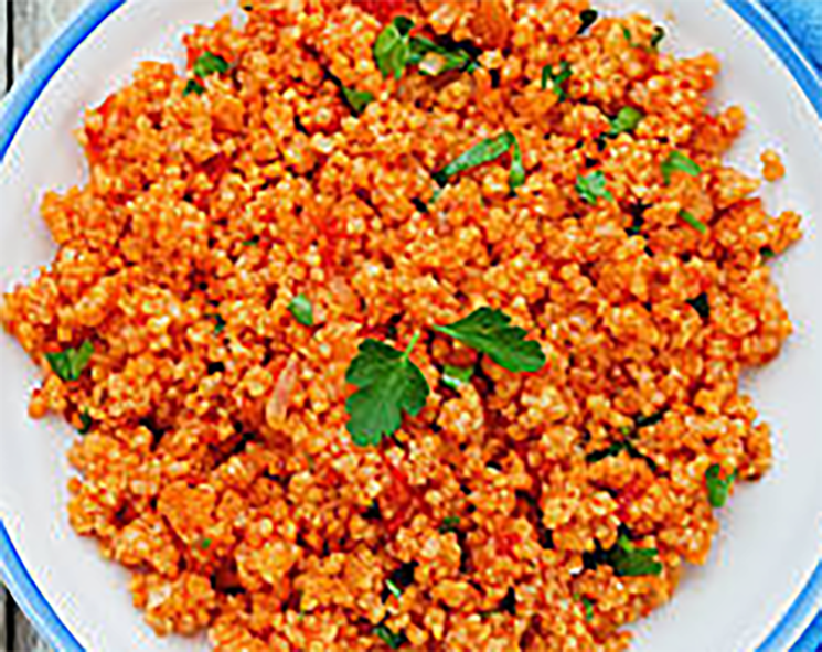 millet cooked in a spiced tomato sauce served on a plate