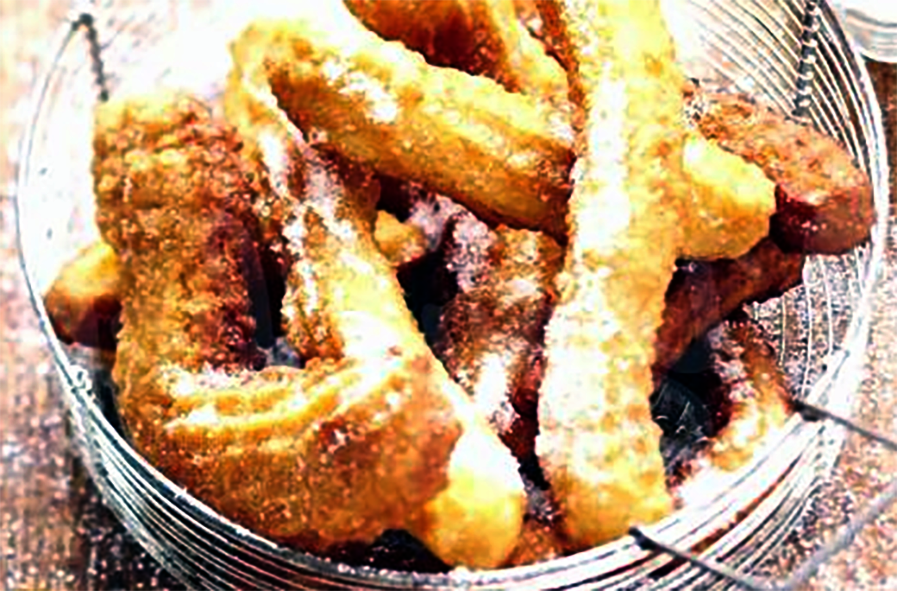 strings of fried chichi millet dough served in a metal basket