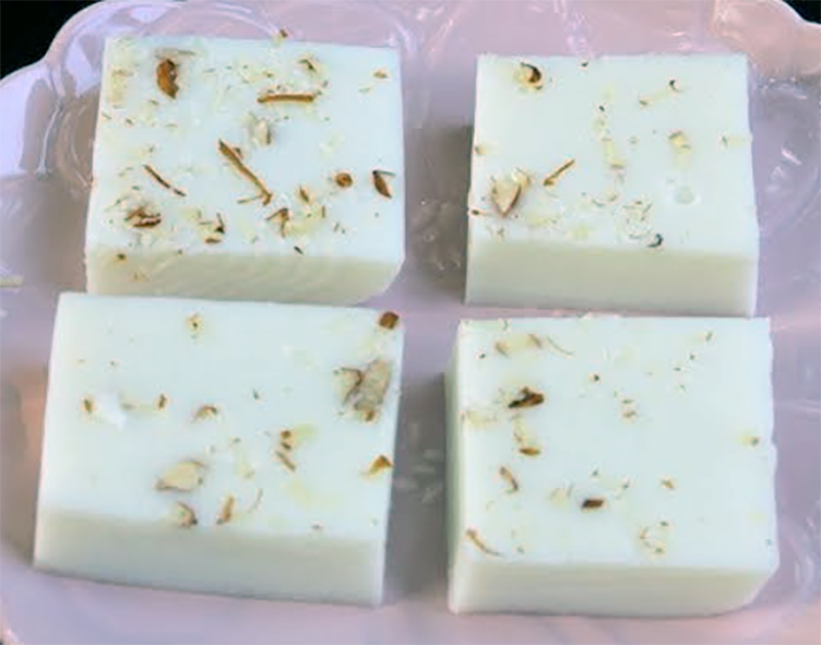 squares of china grass with nut pieces set in the mixture arranged on a plate.