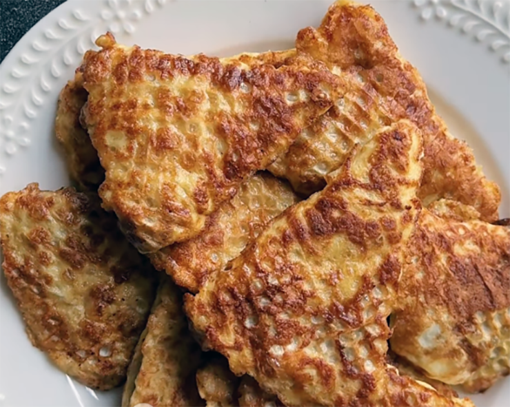 pork cutlets cooked in paper parcels arranged on a white dish