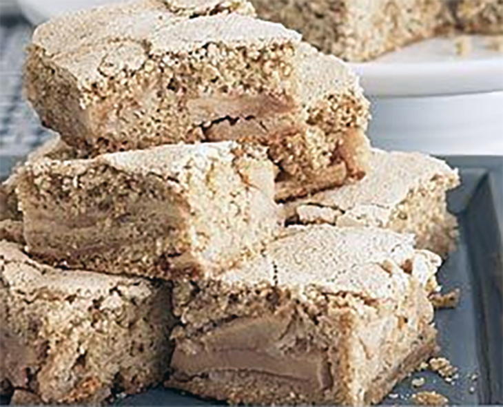 squares of cinnamon apple cake piled on a plate