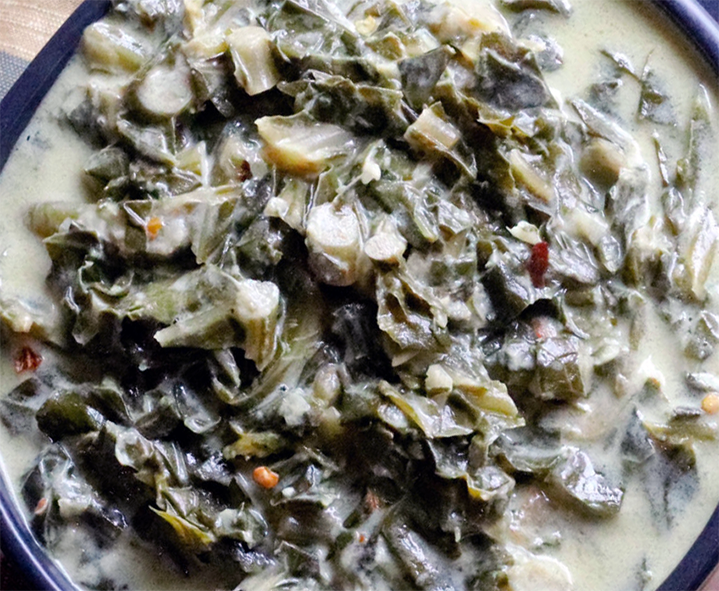 collard greens in coconut milk served in a bowl