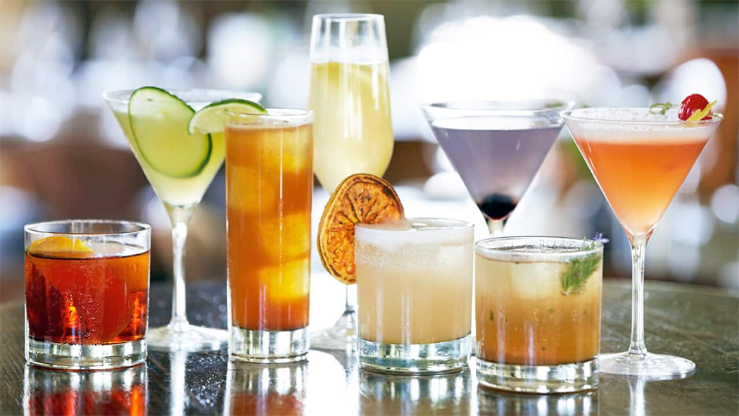 Range of cocktails on a bar.