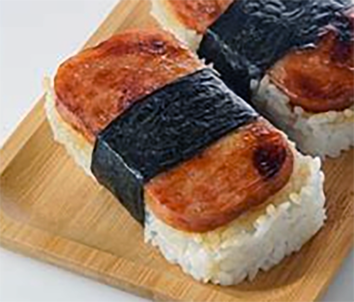 corned beef musubi on a wooden serving dish