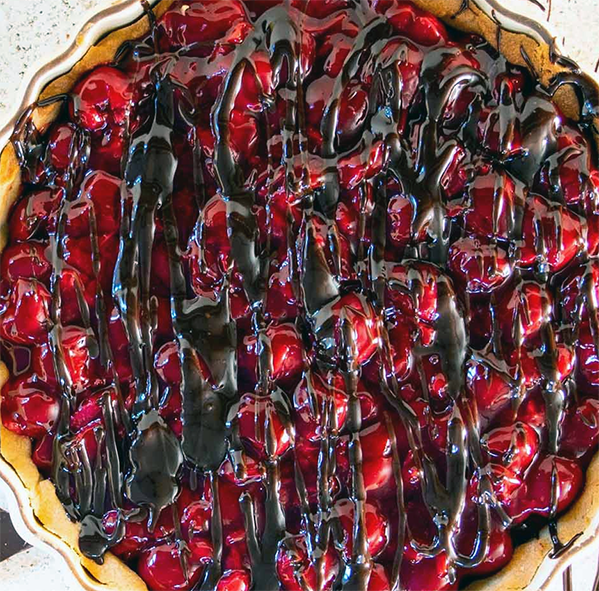 cornelian cherry tart drizzled with melted dark chocolate