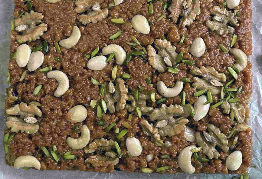 set courgette halwa topped with nuts ready for cutting