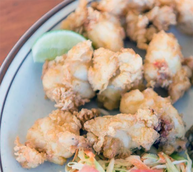 cracked conch or breaded and fried conch served with a wedge of lime>