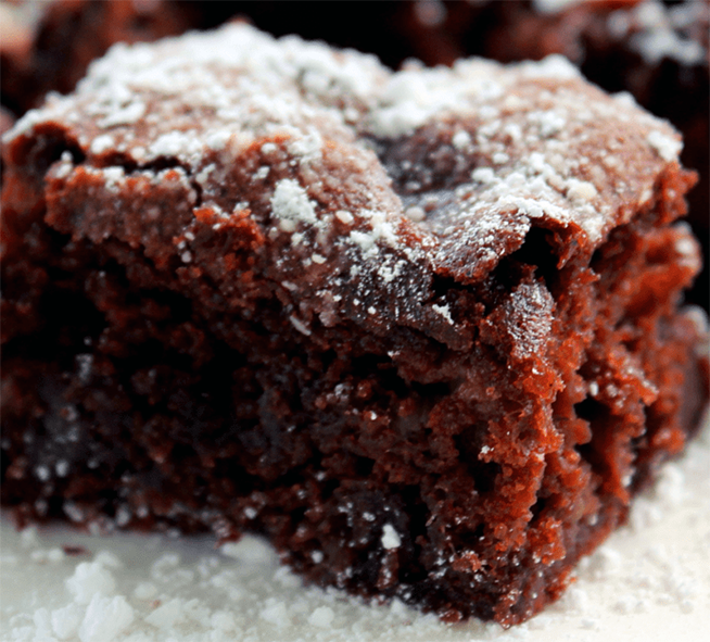 square of slow cooker chocolate and rhubarb cake served dusted with icing sugar
