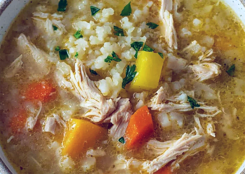 canja, chicken stew/soup with rice and vegetables served in a bowl