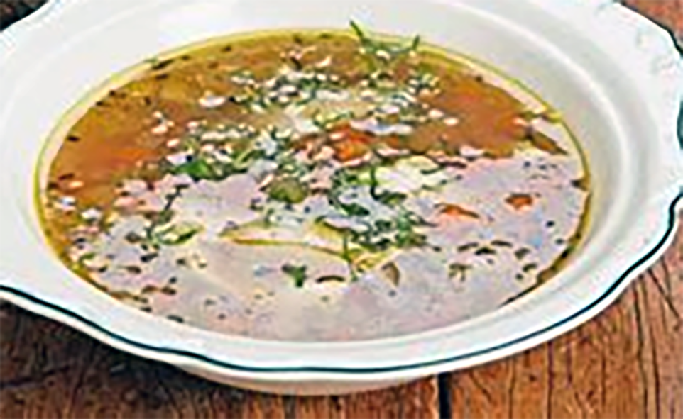 Estonian dark beer soup with pork served in a soup bowl