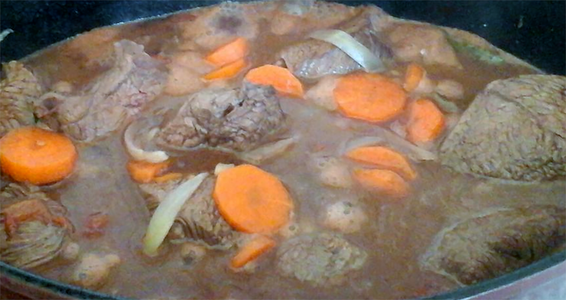 Venison daube cooking in an oval casserole dish