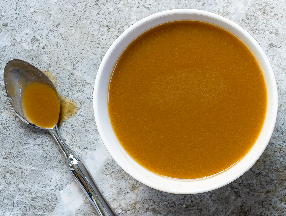 Demi-glace sauce in a white ramekin