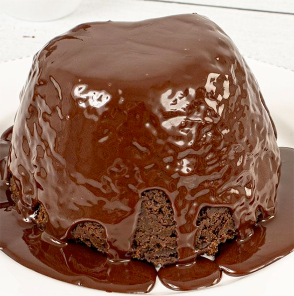 baked chocolate sponge pudding served on a dessert plate with chocolate sauce