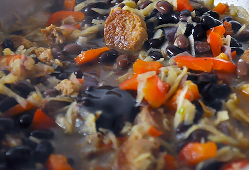 Feijoada (bean and meat stew) served in a steel bowl