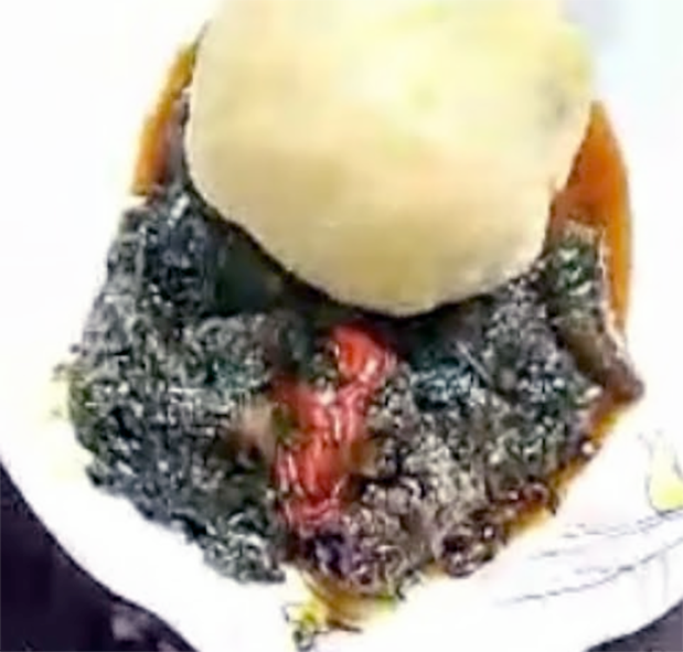 Eru on a white plate with a ball of garri above