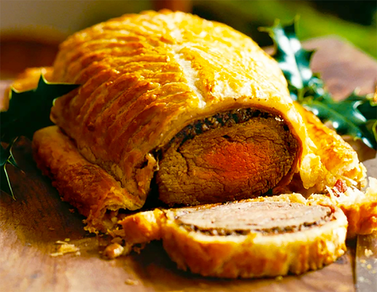 festive venison wellington, sliced and garnished with holly