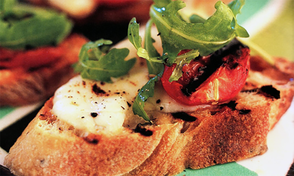 toasted ciabatta topped with tomatoes and rocket leaves
