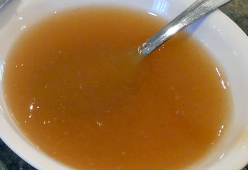 Arrowroot sauce in a white bowl with a spoon