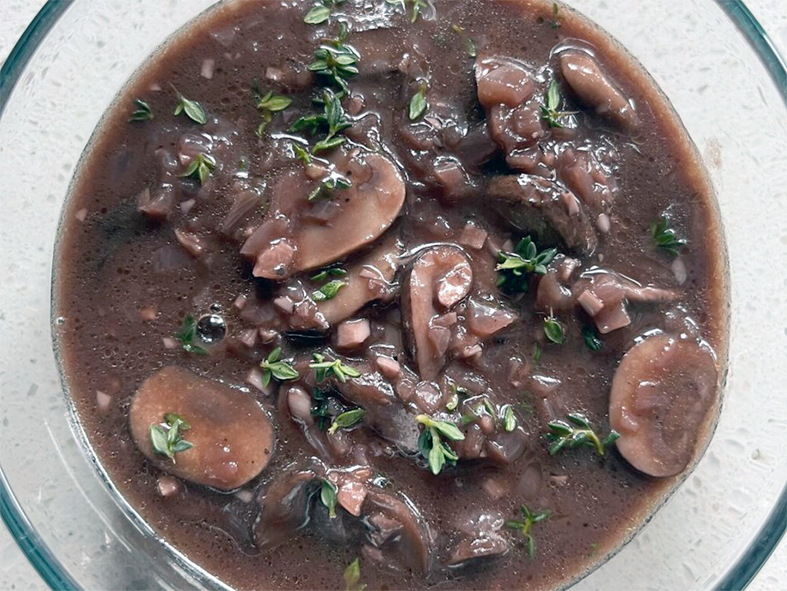 Bourguignotte sauce of mushrooms, red wine and brown sauce in a glass bowl