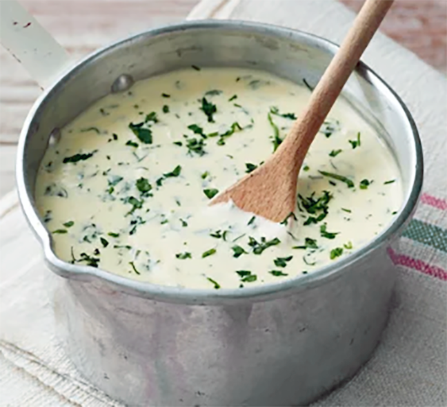 Parsley sauce is a saucepan stirred with a wooden spoon