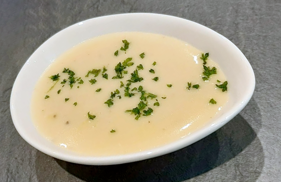 sauce poulette presented in a white egg-shaped bowl