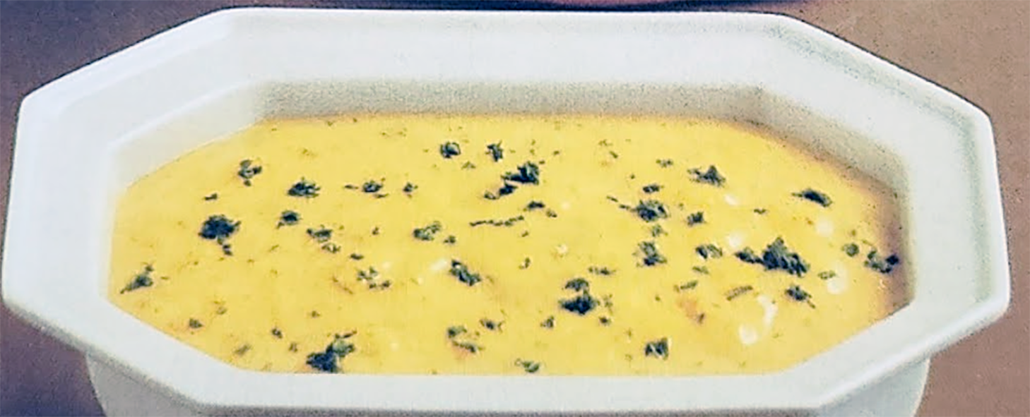 ravigotte sauce of blanched parsley in a bechamel base served in a rectangular white dish