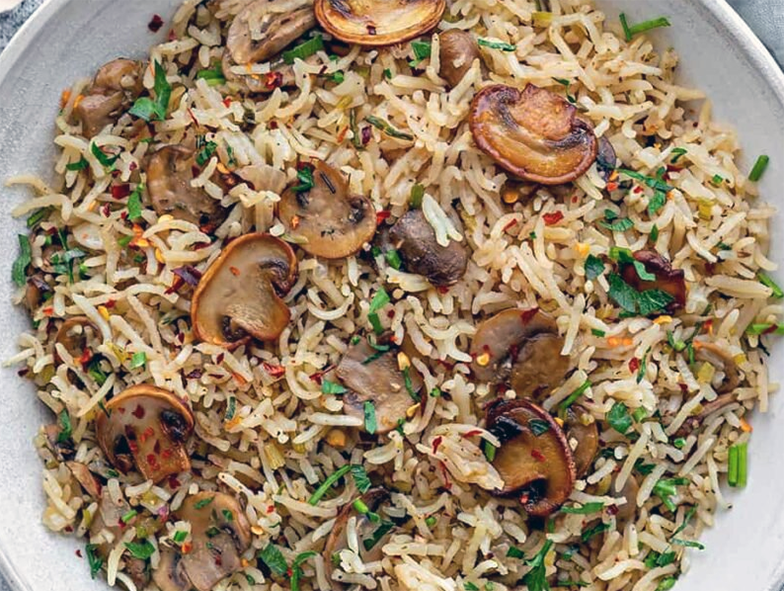 fried rice with mushrooms and bergamot in a bowl