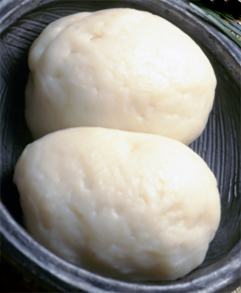 two pieces of Beninese fufu made with youghurt in a glass dish