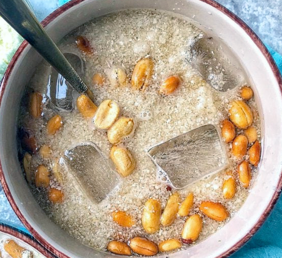 gari soaked in a milk served chilled with ice cubes