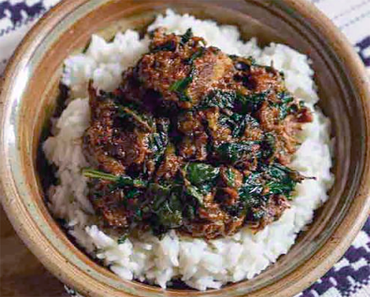 shoko of beef and amaranth leaves served in a bowl on a bed of rice