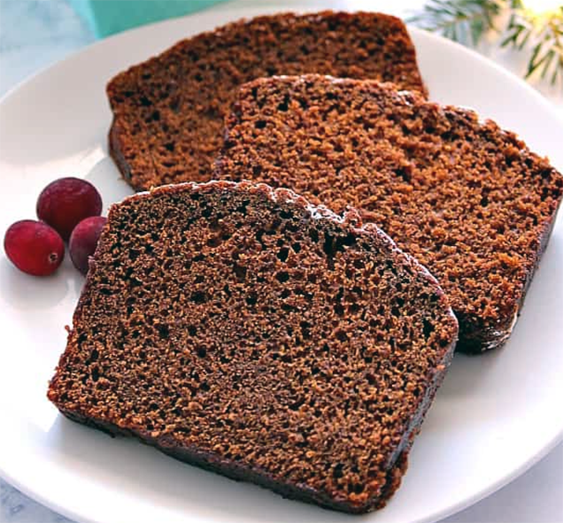 three slices of Irish ginger cake served on a plate with raspberries