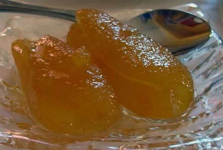 Cypriot preserve of peeled and cored baby apples in sugar syrup served on a glass dish