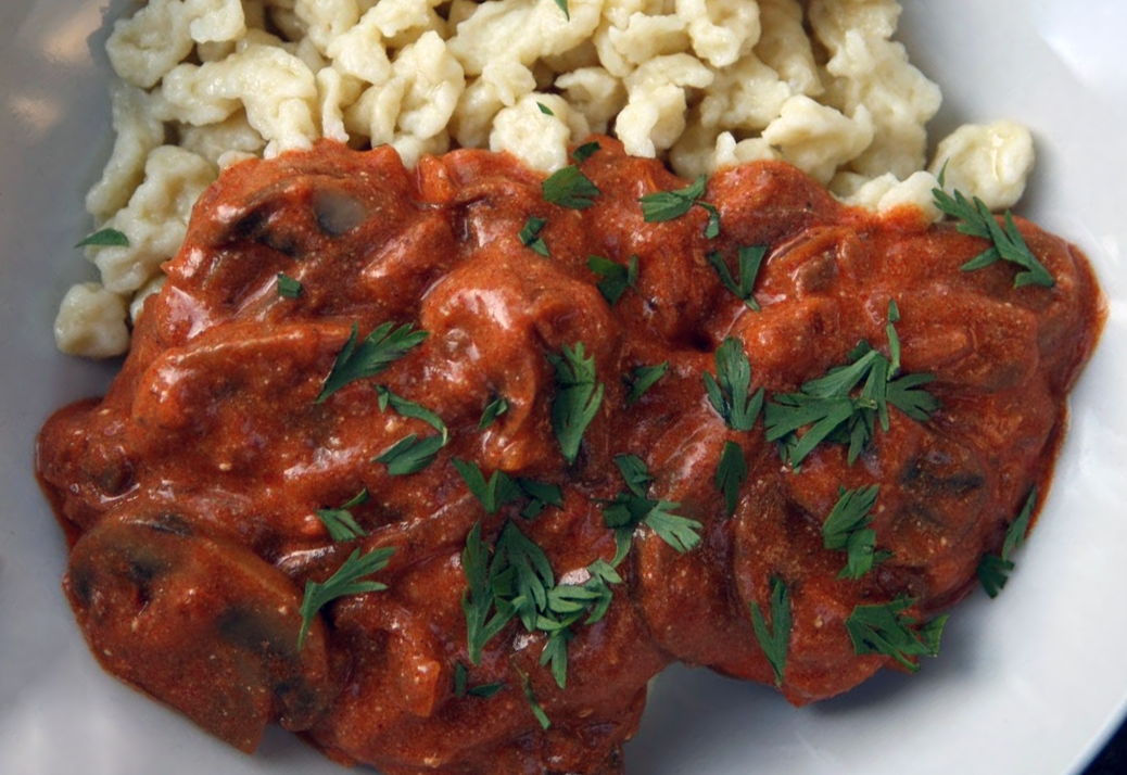 mushroom paprikash served on a plate with noodles