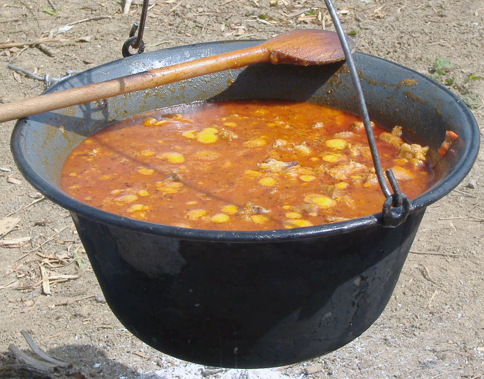 Classic goulash cooking outdoors in a traditional bogrács.