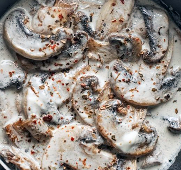 stew of mushrooms with sour cream in a skillet
