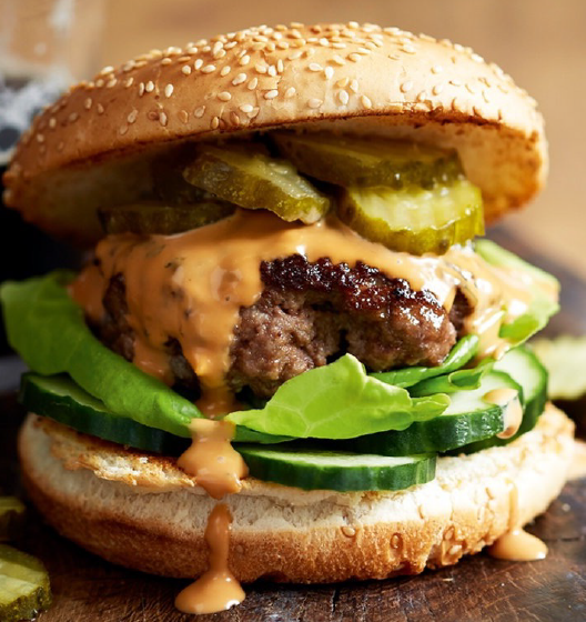 guinness burger in a bun with salad and guinness sauce