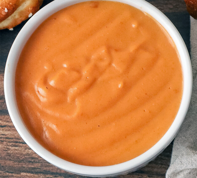 Guinness cheese sauce in a white ramekin