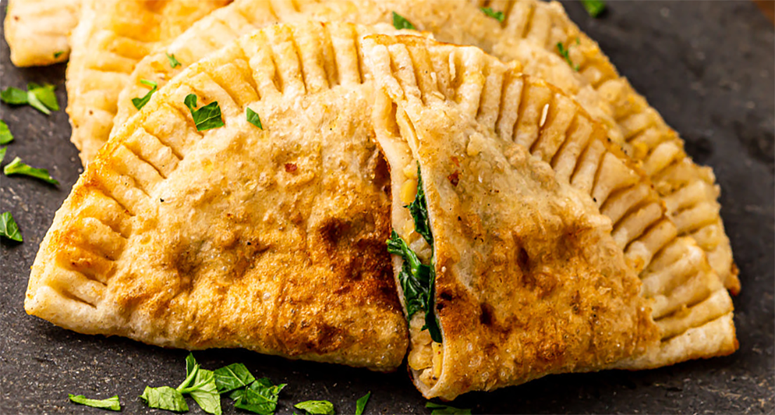 fried herb-stuffed gutap pastries served on a plate