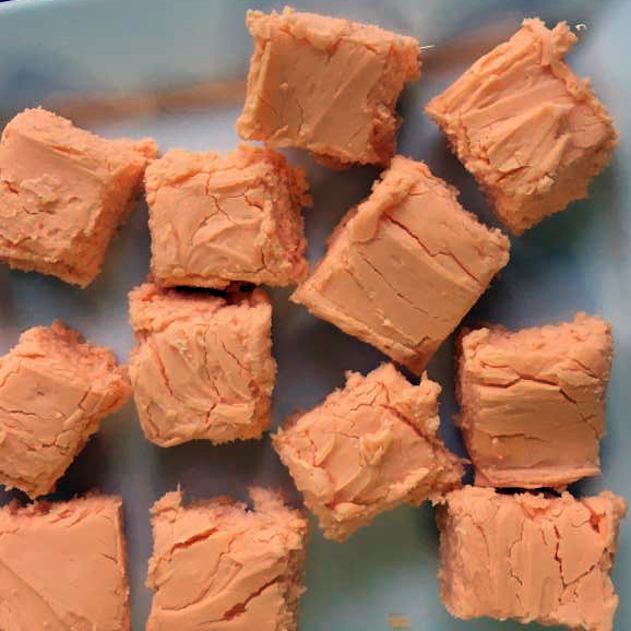 orange-coloured squares of Halloween fudge arranged on a white plate