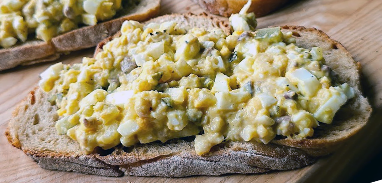 Polish hekele or herring starter served on a slice of bread