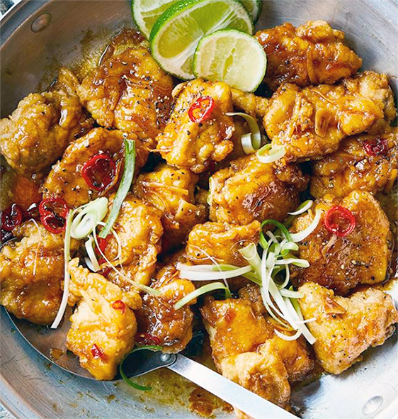 honey chilli chicken being finished in a wok