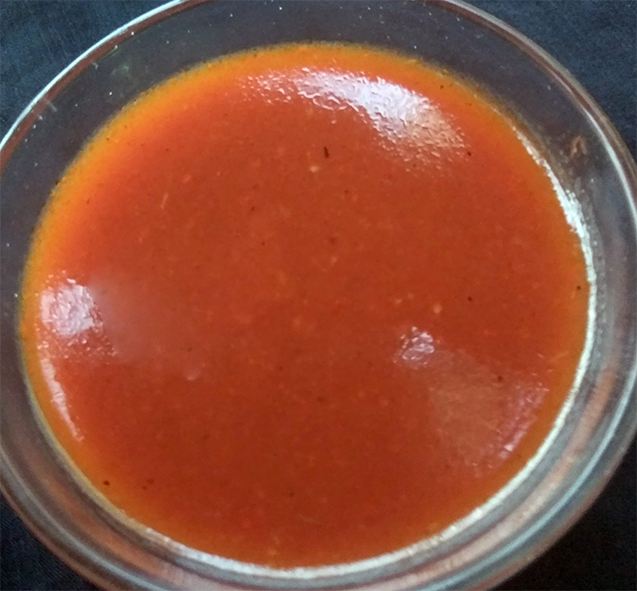 hot and sour tomato sauce in a glass dipping bowl