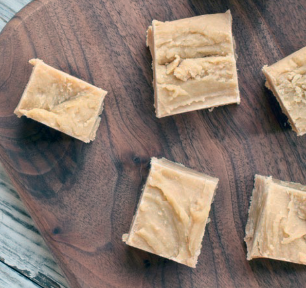 oblongs of white irish cream fudge on a wooden tray