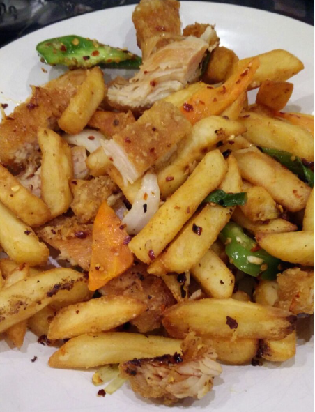 chips and chicken from an Irish spice bag turned out onto a white plate