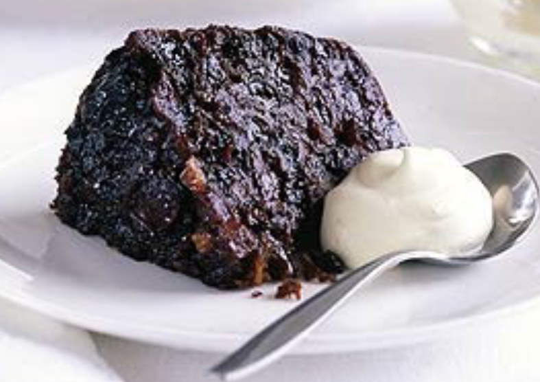 Wedge of Irish stout pudding served with a dollop of whiskey cream