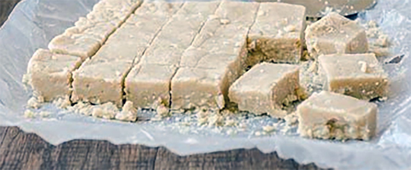halva cut into squares on a piece of greaseproof paper