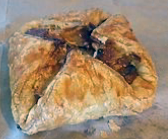 folded ham and cheese pastries on a marble counter top