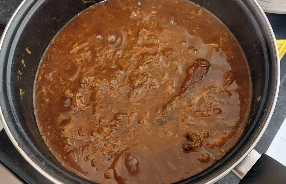 Japanese knotweed compote stewing in a saucepan