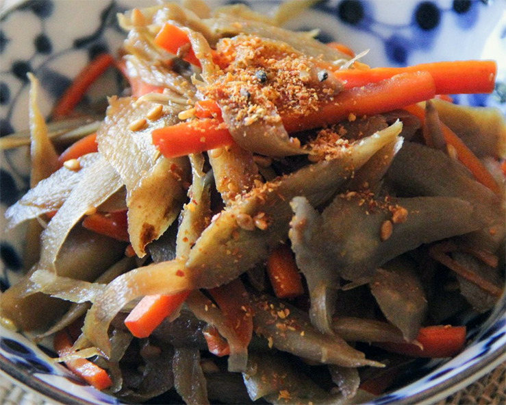 kinpira gobo in a small japanese bowl with Shichimi Togarashi topping