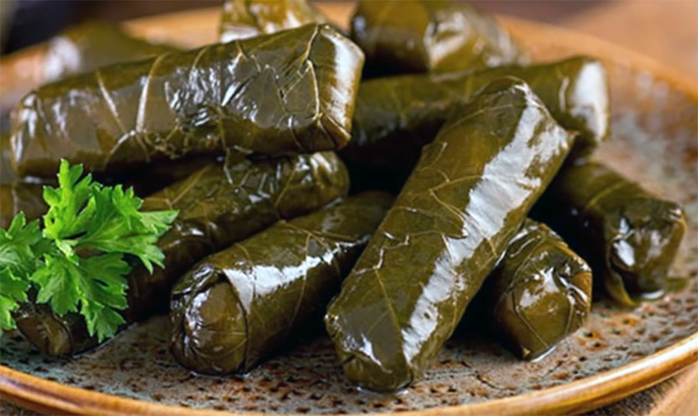 Japrak, stuffed vine leaves arranged on a plate